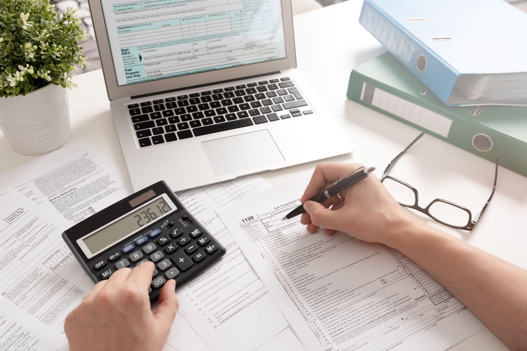Person using calculator and taking notes